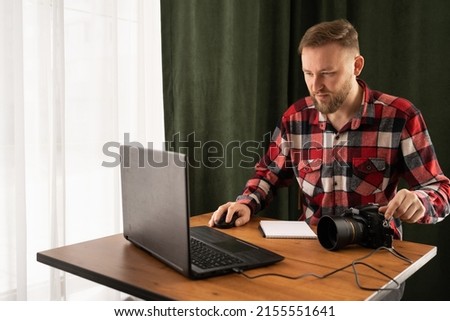 Photographer off loading files on laptop. Checking photos working at modern office or home . Close up of photographer editing his images on pc, copy space