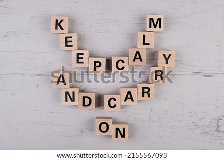 wooden blocks building the word KEEP CALM AND CARRY ON