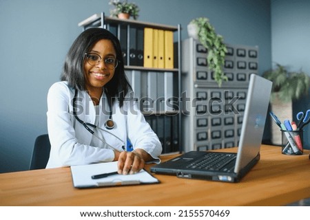 healthcare, medical and technology concept - african female doctor with laptop. Royalty-Free Stock Photo #2155570469