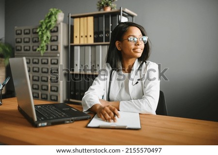 healthcare, medical and technology concept - african female doctor with laptop. Royalty-Free Stock Photo #2155570497