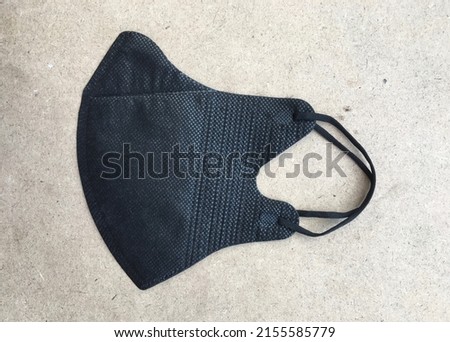 A black mask made of cotton to protect the nose and mouth from viruses or dust