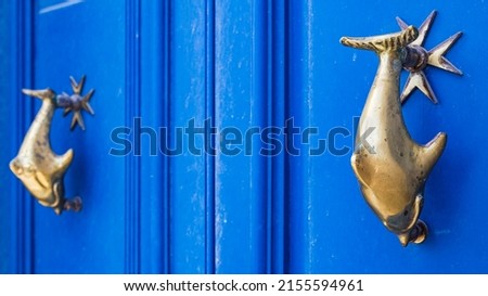 Dolphin door knockers pictured on a blue door in Mdina in the heart of Malta in April 2022.