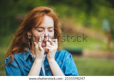 Taking nose drops because of pollen allergy. Woman is having flu and she is using nasal spray to help herself. Woman using nasal spray. Nasal spray to help a cold. Sick woman dripping nose.  Royalty-Free Stock Photo #2155598247