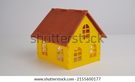 Yellow plastic cartoon house. Rent concept.