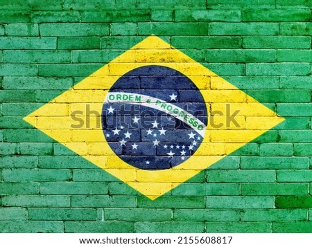 Brazilian flag on a brick wall.