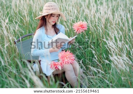 Young girls read books in the garden