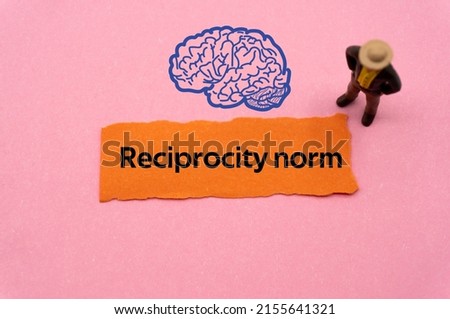 Reciprocity norm.The word is written on a slip of colored paper. Psychological terms, psychologic words, Spiritual terminology. psychiatric research. Mental Health Buzzwords.