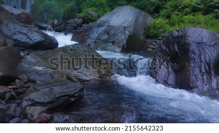 flowing water over river rocks
