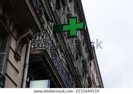 The green cross is the sign of the pharmacy.