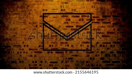 Image of glowing neon envelope icon on brick wall. social media and communication concept digitally generated image.