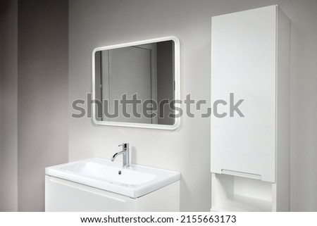 Stoneware countertop bathroom with tired beton wall . White industrial flat loft bathroom with modern countertop basin, square mirror and PVC cupboard. Royalty-Free Stock Photo #2155663173