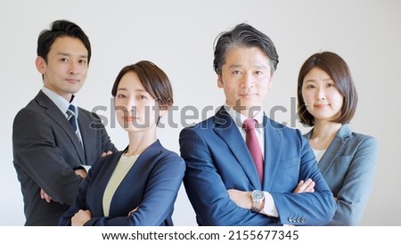 Asian men and women in suits Royalty-Free Stock Photo #2155677345