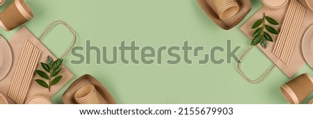 Banner with eco-friendly tableware - kraft paper food packaging on light green background with copy space. Street food paper packaging, recyclable paperware, zero waste packaging concept. Flat lay Royalty-Free Stock Photo #2155679903