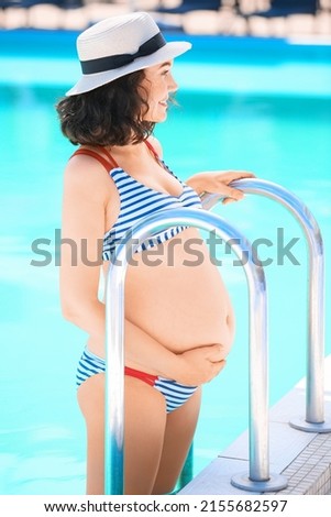 Pregnant woman near swimming pool