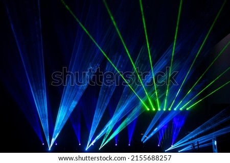 Laser show beams. Many colorful rgb lazer light beams at a concert or a rave party show. Night club flyer design background