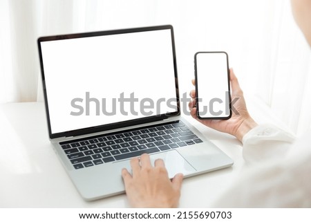 computer screen,cell phone blank mockup.hand woman work using laptop texting mobile.white background for advertising,contact business search information on desk in cafe.marketing,design Royalty-Free Stock Photo #2155690703