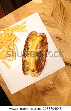 Delicious homemade hotdog on the table with french fries 