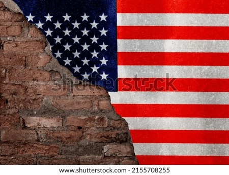 American flag on broken brick wall.