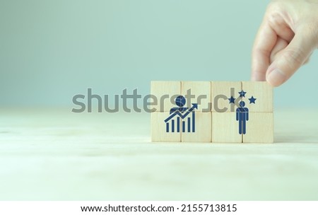 Personal development, growth mindset and promoted employee. Human resource management and training. Enhancing competency, self learning, experience. Wooden cubes with improvement and promoted icons.