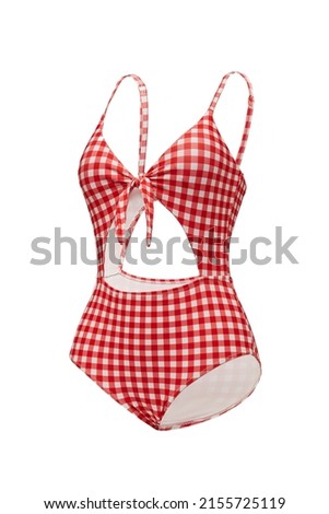 Close-up shot of a red and white checkered cutout one piece swimsuit with a bow. The bathing suit is isolated on a white background. Side view.
