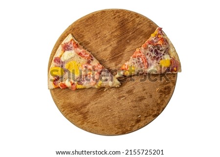 two slices of pizza on a round wooden board on a white background top view