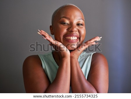 A young Black model holds hands under her face posing Royalty-Free Stock Photo #2155734325
