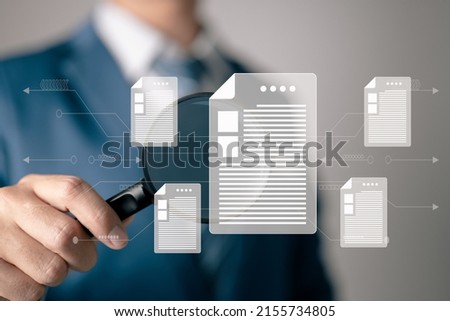 A man examines a paper with a magnifying glass. Business analysis, audit, professional documentation review, inquiry, and inspection concepts. Royalty-Free Stock Photo #2155734805