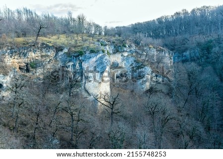 View of rocky cliffs and contours of the forest with treetops.