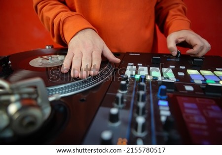 Hip hop dj scratching vinyl record on turntables. Disc jockey playing music on party in night club. Royalty-Free Stock Photo #2155780517