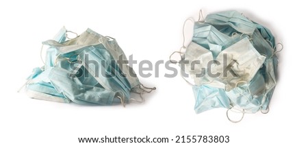 pile of used dirty surgical protective face mask, blue disposable hygienic medical face mask, infectious waste concept, isolated on white background, collection Royalty-Free Stock Photo #2155783803