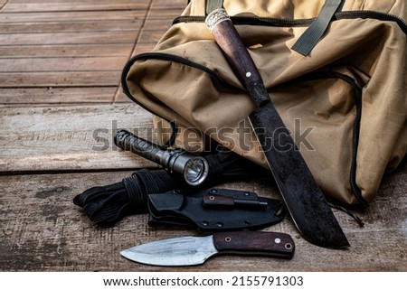 A knife with equipment for survival in the forest 