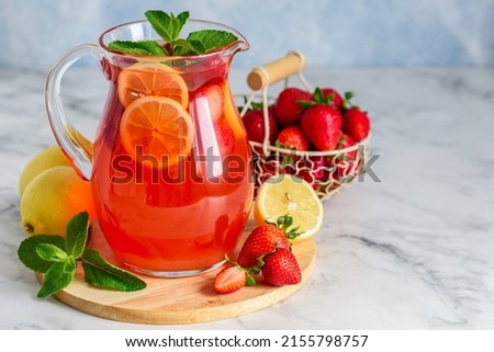 Strawberry lemon lemonade with mint in jug. Summer refreshing drink.  Detox fruit water. Selective focus. Copy space Royalty-Free Stock Photo #2155798757