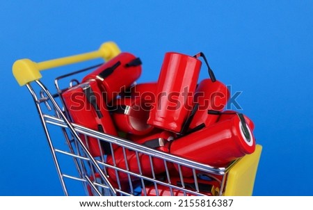 Batteries in a shopping cart on a blue background