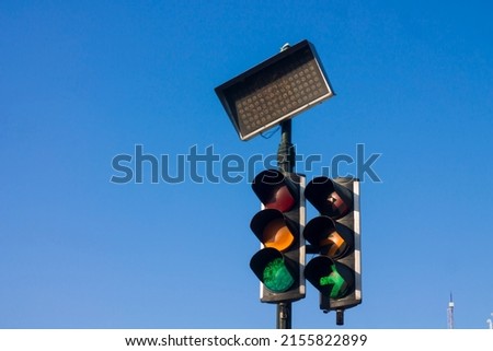 Low Angle View Of traffic lights Against Blue Sky. urban traffic lights