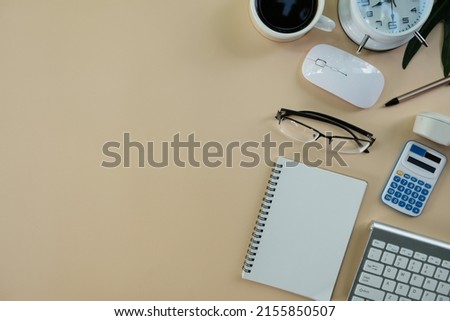 Top view above of office desk table with laptop, notebook and coffee cup with equipment other office supplies. Business and finance concept. Workplace, Flat lay with blank copy space.