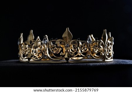 close up portrait of royal golden crown, isolated on dark black background.