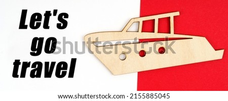 Vacation and entertainment concept. On a red and white background, a figure of a yacht and an inscription - Let is go travel