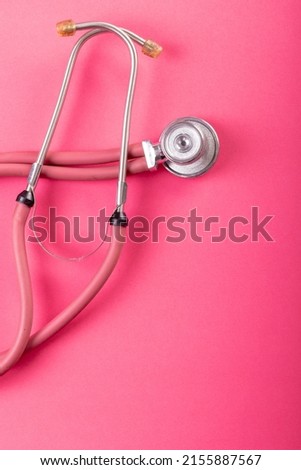 Close-up of pink stethoscope isolated against pink background, copy space. medical, equipment, heart, cardiology and healthcare concept.