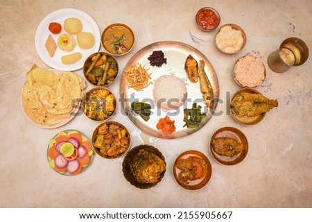 Bengali food thali in kolkata. bengali thali for puja and Pailaboishakh. Bengali Thali with Vegetables , Chicken , Prawn, Ilish and Sweets Royalty-Free Stock Photo #2155905667