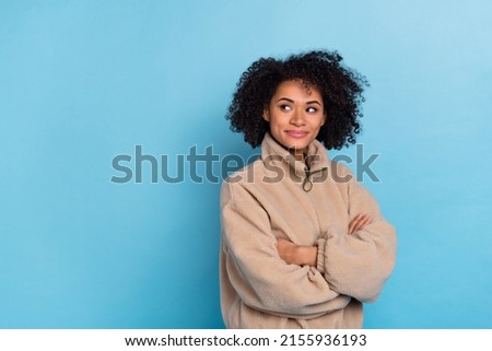 Photo of minded lady cross hands look empty space guess decision wear artificial fur outfit isolated blue color background