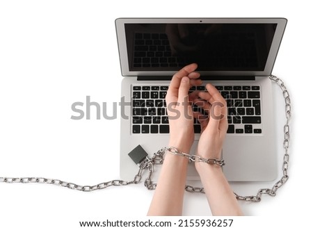 Woman showing hands chained to laptop on white background, top view. Internet addiction
