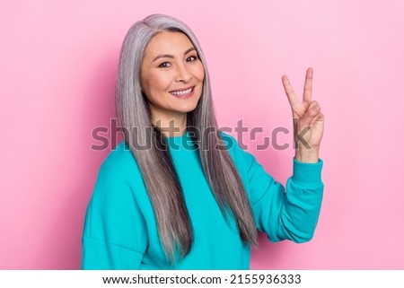 Photo of satisfied funny person hand fingers show v-sign toothy smile isolated on pink color background