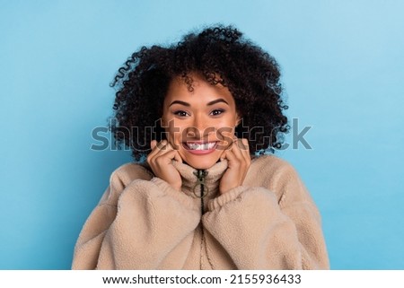 Portrait of positive lady hold artificial fur outfit cold weather enjoy fresh softness isolated blue color background Royalty-Free Stock Photo #2155936433