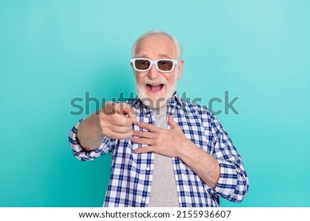 Photo of cheerful overjoyed ecstatic grandfather laughing watching comedy film isolated on teal color background