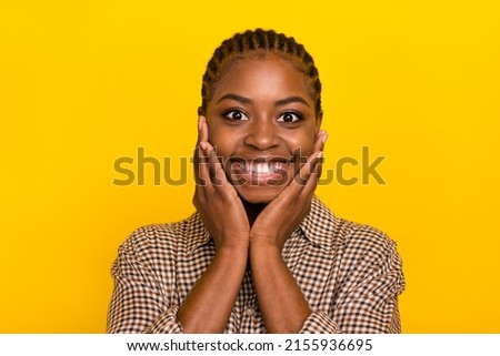 Photo of shiny excited lady dressed checkered shirt arms cheeks smiling isolated yellow color background Royalty-Free Stock Photo #2155936695