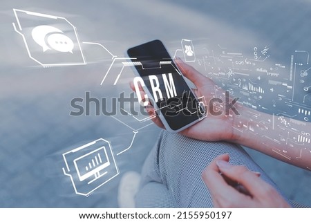 Customer relationship management or CRM. Phone in hand with abstract icons