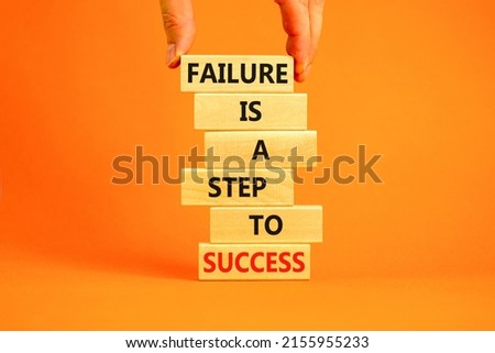 Failure or success symbol. Wooden blocks with words A failure is a step to success. Beautiful orange table orange background. Businessman hand. Business, failure or success concept. Copy space.