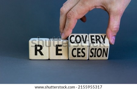 Recovery and recession symbol. Businessman hand turns cubes and changes the word 'recession' to 'recovery'. Beautiful grey background. Business and recovery - recession concept. Copy space. Royalty-Free Stock Photo #2155955317