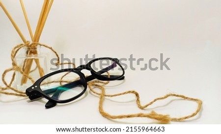 photo of glasses, aromatherapy and a mini plant with a white background and copy space in the studio