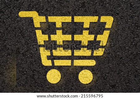 Asphalt road with yellow shopping cart symbol